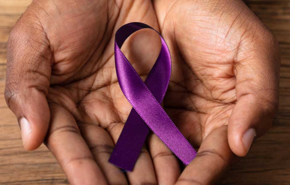 Hands holding a purple ribbon for Alzheimer’s and Brain Awareness Month