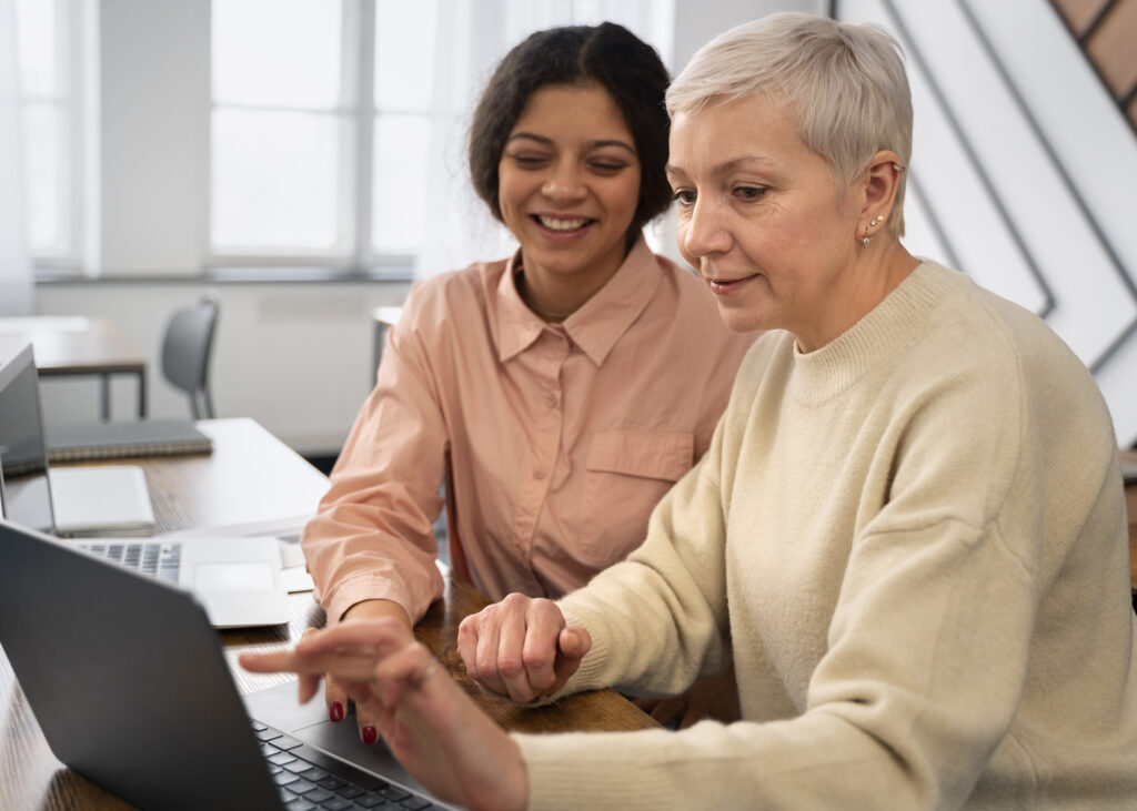 two women are working together on a computer